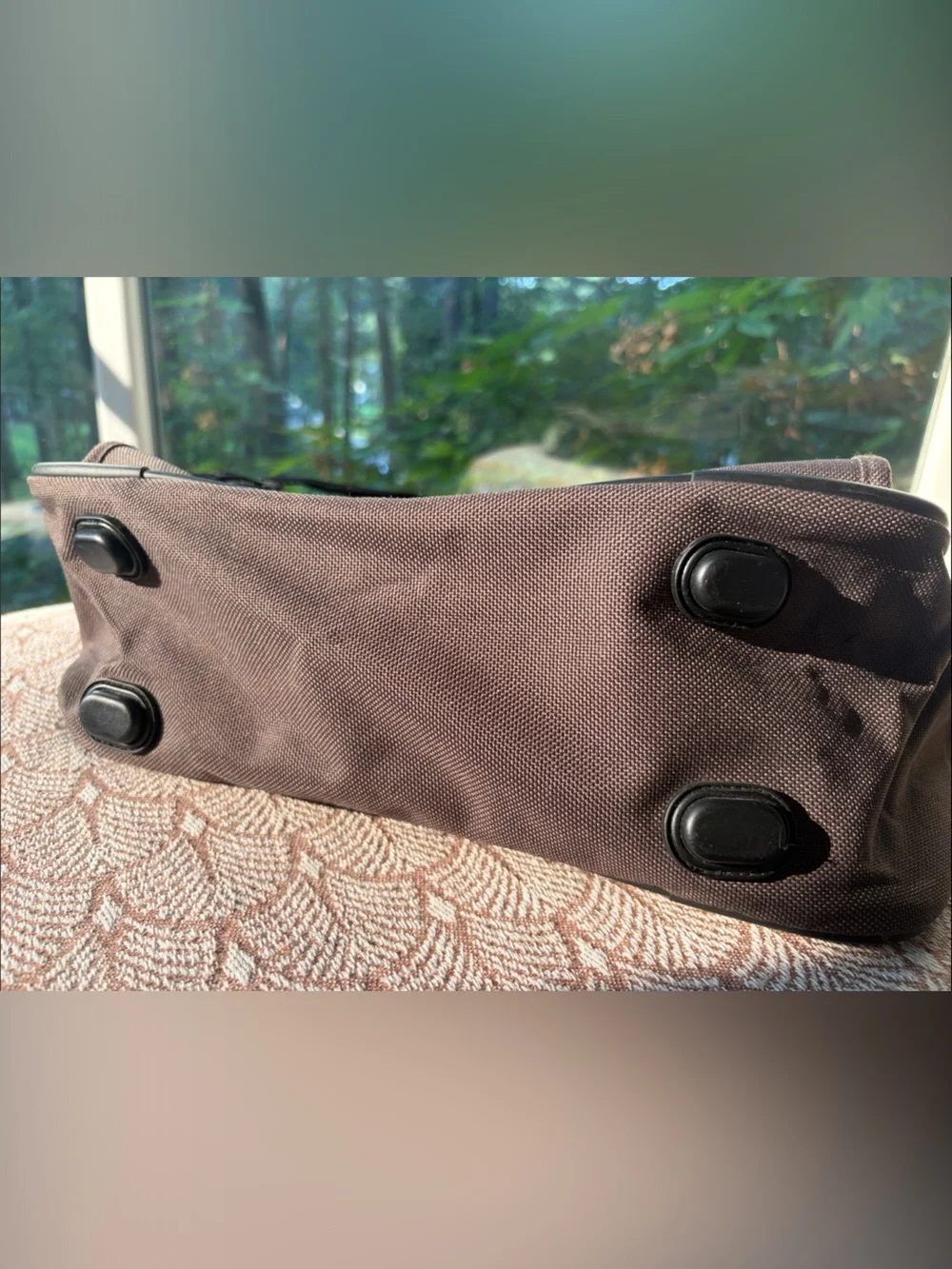 Eddie Bauer army green carry-on bag with black hand straps and shoulder strap
